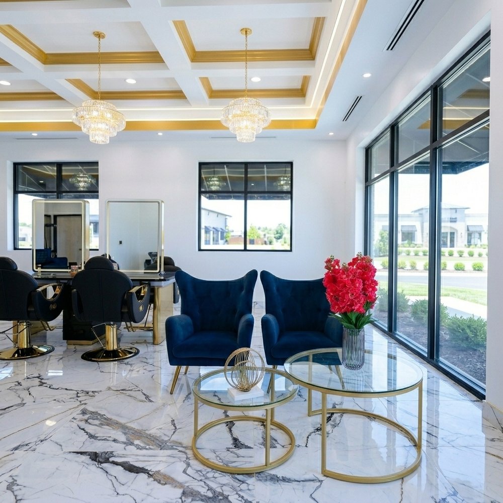 The waiting area with blue velvet chairs and gold tables